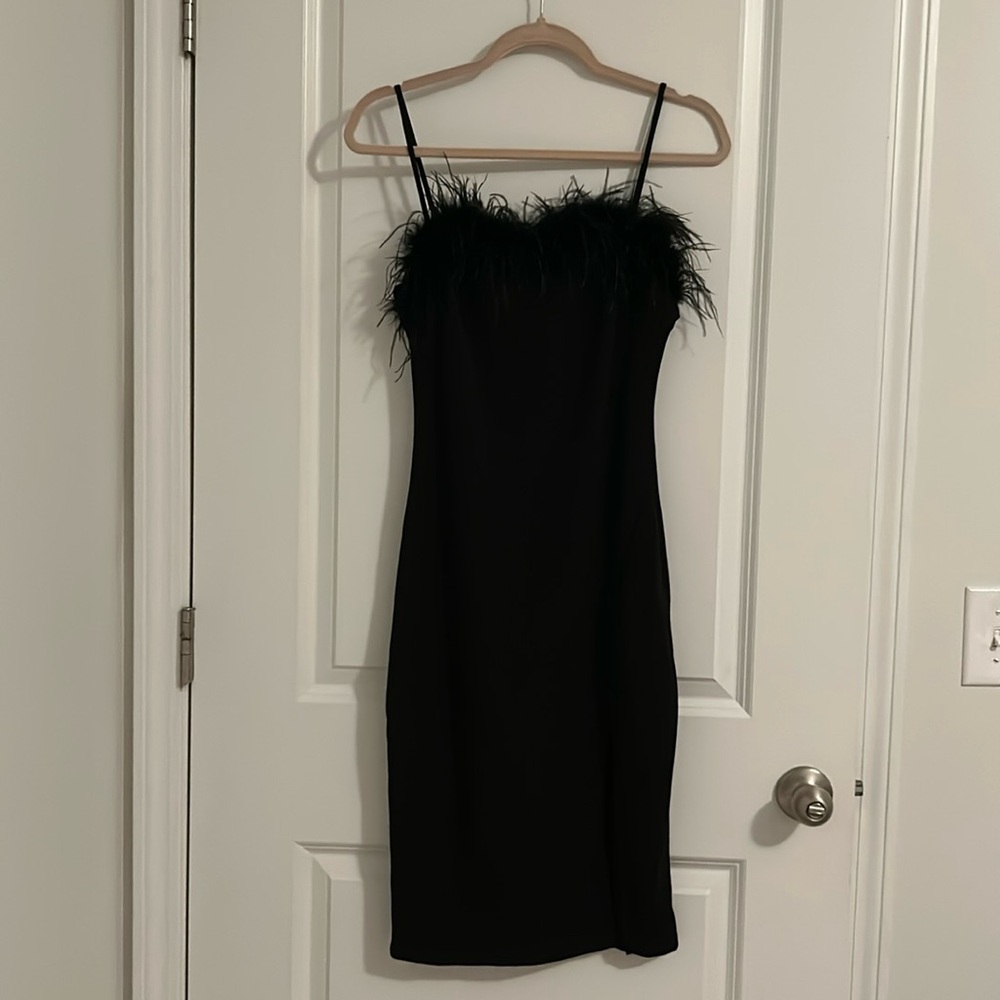Lightly worn black dress with side slit and feather neckline